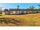 Tan single-story building with metal roof and grassy yard at 4235 Stratford Dr, New Port Richey, FL 34652