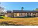 Tan single-story building with metal roof and grassy yard at 4235 Stratford Dr, New Port Richey, FL 34652