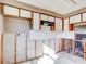 A kitchen undergoing renovation, showing exposed walls and new flooring at 4235 Stratford Dr, New Port Richey, FL 34652