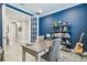 Study with blue walls, wood desk, and built-in shelving at 4242 Isonzo Way, Wesley Chapel, FL 33543