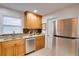 Bright kitchen with stainless steel appliances and wood cabinets at 5713 86Th N Ave, Pinellas Park, FL 33782