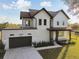 Elevated perspective of a two-story home with rooftop access, gray garage door, and green lawn at 6303 Barton Rd, Plant City, FL 33565