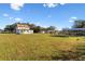 Modern two-story home with a white exterior and a large green lawn at 6303 Barton Rd, Plant City, FL 33565