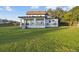 Backyard view of a two-story home with a covered patio and lush green lawn at 6303 Barton Rd, Plant City, FL 33565