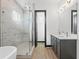 This primary bathroom boasts a marble tiled shower, dual sinks, and black fixtures at 6303 Barton Rd, Plant City, FL 33565