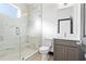 Modern bathroom featuring a glass-enclosed shower with marble-look tile and gray vanity at 6303 Barton Rd, Plant City, FL 33565
