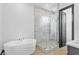This bathroom has a standalone tub, a glass shower with white marble tile, and black trim at 6303 Barton Rd, Plant City, FL 33565