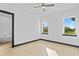 Bright bedroom with two windows, wood-look floors, and an attached bathroom at 6303 Barton Rd, Plant City, FL 33565