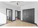 This bedroom features light wood floors, white walls, and dark trim at 6303 Barton Rd, Plant City, FL 33565