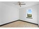 This clean bedroom features light wood floors, white walls, and a large window at 6303 Barton Rd, Plant City, FL 33565