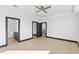 Large bedroom with ceiling fan and multiple doorways leading to closet and bathroom at 6303 Barton Rd, Plant City, FL 33565