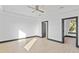 Spacious bedroom with ceiling fan, light wood-look flooring, and modern trim at 6303 Barton Rd, Plant City, FL 33565
