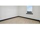 Empty bedroom with window, wood-look flooring, and white walls at 6303 Barton Rd, Plant City, FL 33565