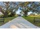 Modern two-story home with a large driveway and beautiful mature trees at 6303 Barton Rd, Plant City, FL 33565