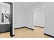 Hallway with light wood floors leading to bathroom with modern vanity and staircase at 6303 Barton Rd, Plant City, FL 33565