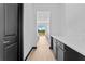 Long hallway with storage cabinets and white countertops near kitchen and black door at 6303 Barton Rd, Plant City, FL 33565