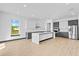 Spacious kitchen with quartz island, stainless appliances, and gray/white cabinets at 6303 Barton Rd, Plant City, FL 33565