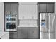 Modern kitchen with stainless steel appliances, gray cabinets, and white countertops at 6303 Barton Rd, Plant City, FL 33565