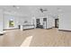 Spacious kitchen with modern two-tone cabinets, stainless steel appliances and light wood floors at 6303 Barton Rd, Plant City, FL 33565