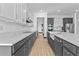 Modern kitchen with white and gray cabinetry, stainless steel appliances, and quartz countertops at 6303 Barton Rd, Plant City, FL 33565