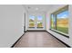 Bright room with large windows, black trim and neutral-colored walls and light wood floors at 6303 Barton Rd, Plant City, FL 33565