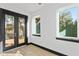 This room has dark framed windows, light wood floor, and dark framed french doors at 6303 Barton Rd, Plant City, FL 33565