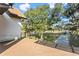 A side view from a patio with trees, grass, a walkway, and a blue sky at 6303 Barton Rd, Plant City, FL 33565