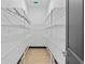 Bright walk-in closet featuring ample shelving and wood-look floors at 6303 Barton Rd, Plant City, FL 33565