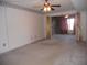 Spacious bedroom with carpet flooring, ceiling fan, and an adjacent room at 6400 46Th N Ave # 105, Kenneth City, FL 33709