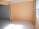 Bonus room with peach-colored walls, tile floor, and folding doors at 6400 46Th N Ave # 105, Kenneth City, FL 33709