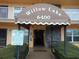 Entrance to the Willow Lake building with an awning, stone facade, and tow-away zone sign at 6400 46Th N Ave # 105, Kenneth City, FL 33709