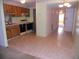 Dated kitchen with wood cabinets, white appliances, and tile floor at 6400 46Th N Ave # 105, Kenneth City, FL 33709