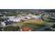 Aerial view of a school campus with athletic fields, buildings, and surrounding neighborhood at 6400 46Th N Ave # 105, Kenneth City, FL 33709