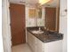 Bathroom with single sink vanity and large mirror at 6400 46Th N Ave # 105, Kenneth City, FL 33709