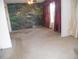 Spacious living room featuring a nature mural and large window at 6400 46Th N Ave # 105, Kenneth City, FL 33709