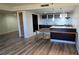 Modern kitchen with dark cabinetry, granite counters, and breakfast bar at 701 S Madison Ave # 416, Clearwater, FL 33756