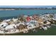 Aerial view of waterfront home with private pool and boat dock at 807 Bay Point Dr, Madeira Beach, FL 33708