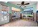 Dining area during renovations, with tiled flooring, door to pool area, and water views at 807 Bay Point Dr, Madeira Beach, FL 33708
