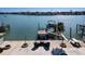 Private waterfront dock with boat lift and seating area at 807 Bay Point Dr, Madeira Beach, FL 33708