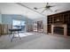Spacious living room with fireplace and water view at 807 Bay Point Dr, Madeira Beach, FL 33708