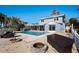 Outdoor pool area with lounge chairs, fire pit and backyard access at 807 Bay Point Dr, Madeira Beach, FL 33708