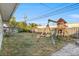 Fenced backyard with a playset and paved area at 9167 108Th St, Seminole, FL 33772