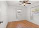 Spacious bedroom with hardwood floors, white walls, and ceiling fan at 9167 108Th St, Seminole, FL 33772