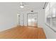 Bedroom with mirrored closet doors, hardwood floors, and ceiling fan at 9167 108Th St, Seminole, FL 33772