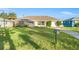 Front view of the home with a grassy lawn and driveway at 9167 108Th St, Seminole, FL 33772