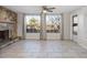 Gathering room with tile floors, a stone fireplace, and large windows at 9167 108Th St, Seminole, FL 33772