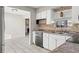 Kitchen with white cabinets, black appliances, and a decorative tile backsplash at 9167 108Th St, Seminole, FL 33772