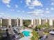 Inviting community pool surrounded by lush greenery and condo buildings at 2700 Cove Cay Dr # 2F, Clearwater, FL 33760