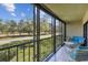 Spacious screened balcony with seating and views of the golf course at 2700 Cove Cay Dr # 2F, Clearwater, FL 33760