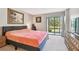 Spacious main bedroom with king-size bed and access to a balcony at 2700 Cove Cay Dr # 2F, Clearwater, FL 33760